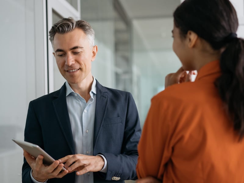 Business executive looking at applicant resume on tablet