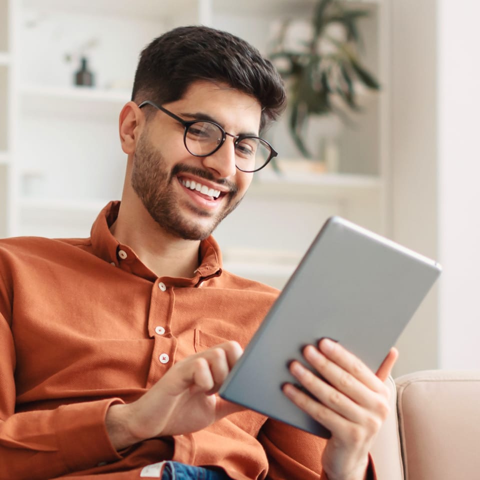 Smiling man using a tablet