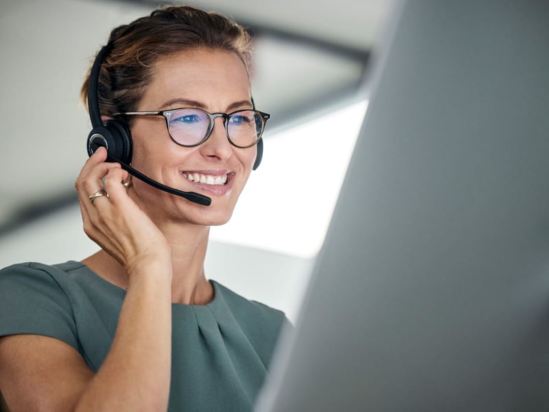 Customer support representative using headset