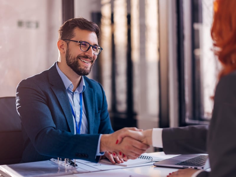 Business man shaking hands with colleague